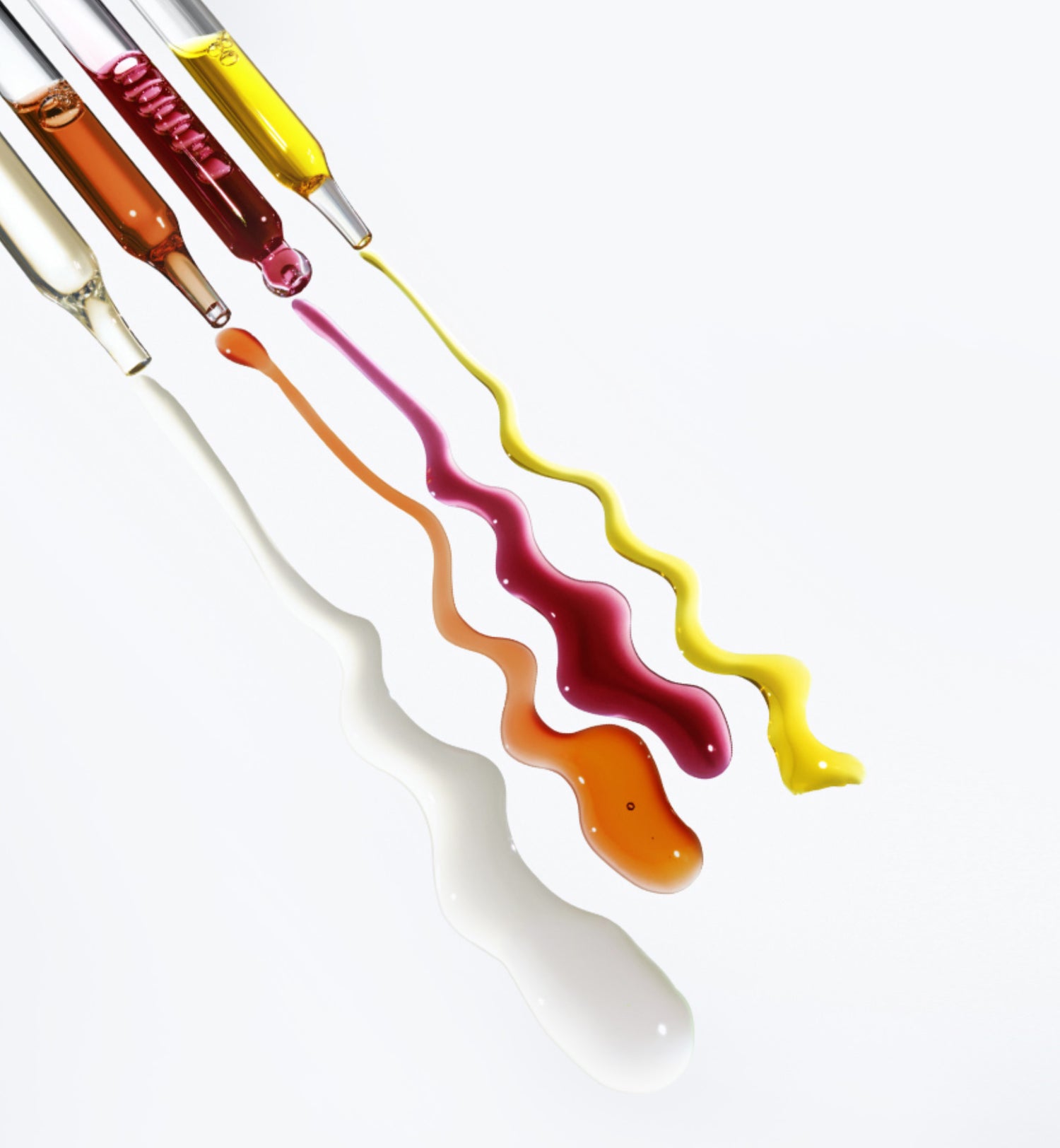 4 pipettes with different color liquids
