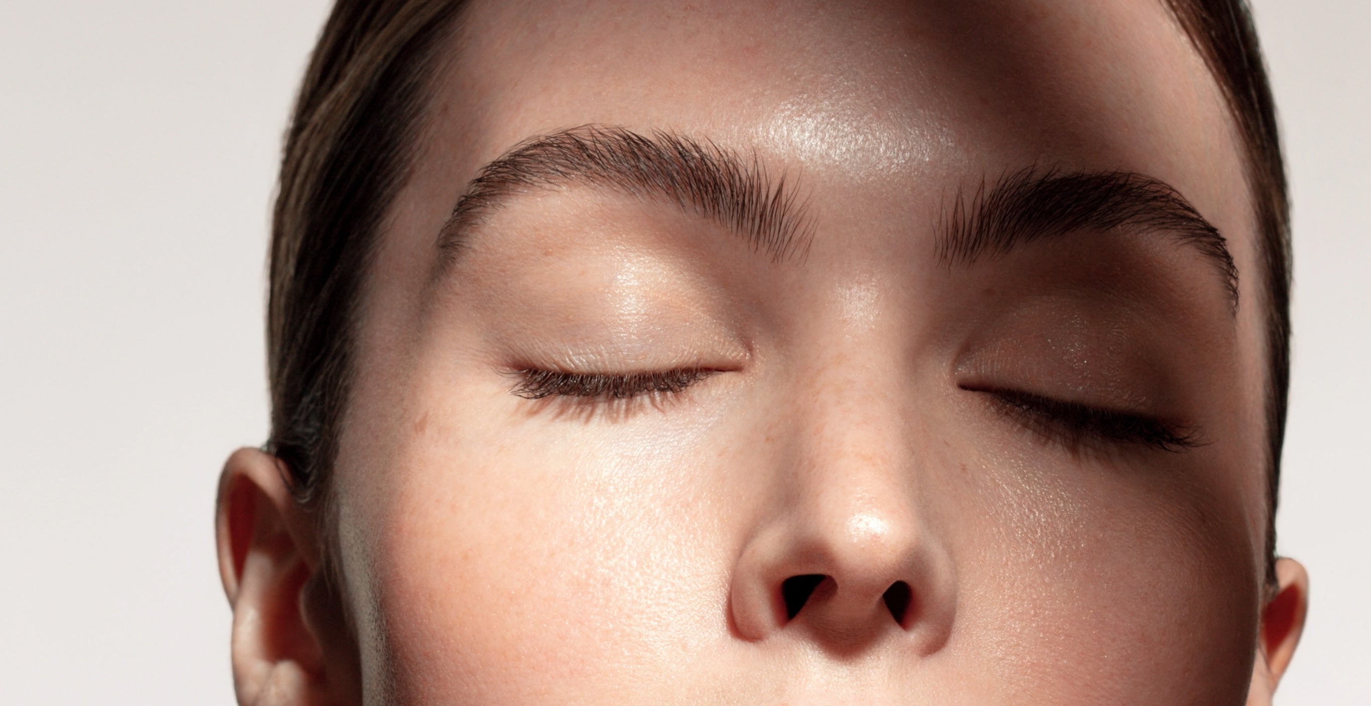 The top portion of a woman's face showing her nose and eyes.